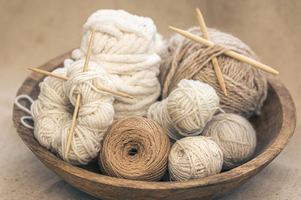 istock Wooden bowl with threads for knitting yarns close-up. 1465652337