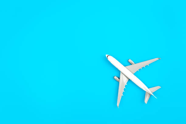 istock White plane, airplane on a blue background, flat lay, copy space. 1465652889