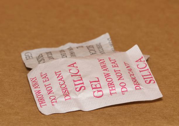 istock Two Silica gel packets isolated in a cardboard box. 1465664194