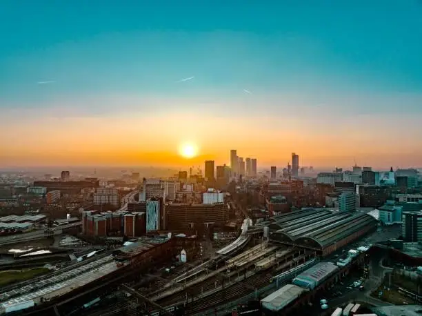 Aerial photograph of Manchester City Centre. Photograph taken of an early evening sunset during winter with skyscrapers and Piccadilly Railway Station in