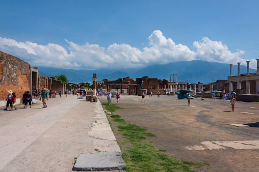 Pompeii, Italy -  June 11, 2016:  Visitors explore Pompeii, an archaeological site in southern Italys Campania region.
