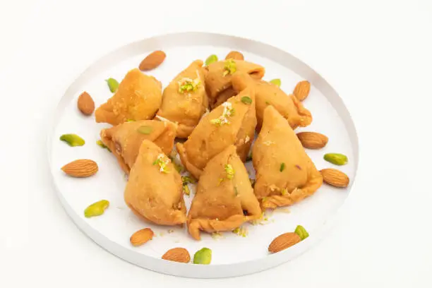 Samosa Gujia Mithai Also Called Gujiya, Pirukiya, Pirukia, Pedakiya, Karanji, Basundi Gughra Made Of Suji Ghee Stuffed With Mawa Khoya Chasni Mava Khoa Is Enjoyed On Deepawali, Teez, Holi And Teej