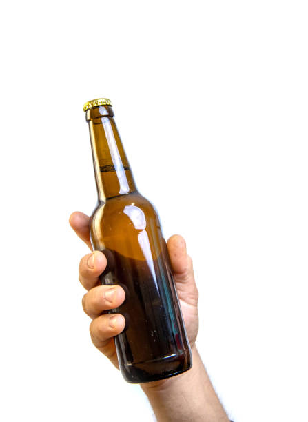 istock Beer bottle in hand isolated on white. 1465669144