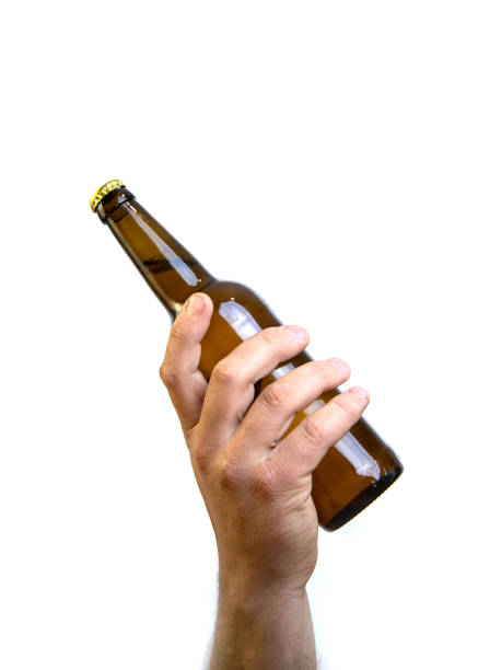 istock Beer bottle in hand isolated on white. 1465669146