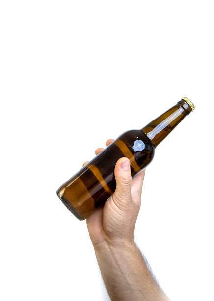istock Beer bottle in hand isolated on white. 1465669150