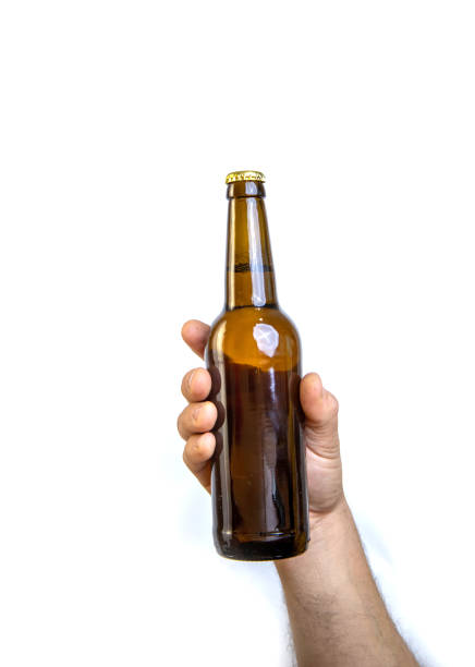 istock Beer bottle in hand isolated on white. 1465669160