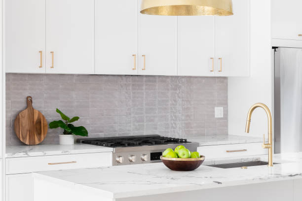 istock A white kitchen detail with gold light and faucet. 1465669312