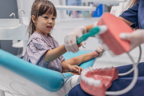 istock Girl learning how to brush teeth 1465669481