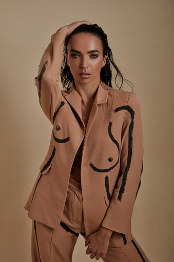 Wet haired woman in a brown suit.