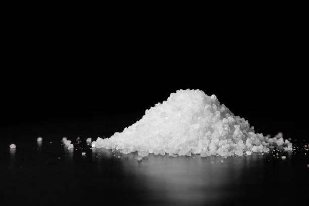 istock A handful of coarse white salt on a black table 1465670295