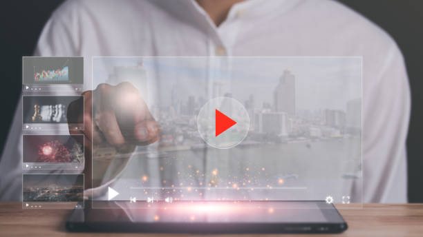 istock man pointing at virtual icon, to watch videos via wireless technology,Training, learning, teaching,virtual reality used in online video conferencing,Online streaming Watch videos on Internet 1465670638