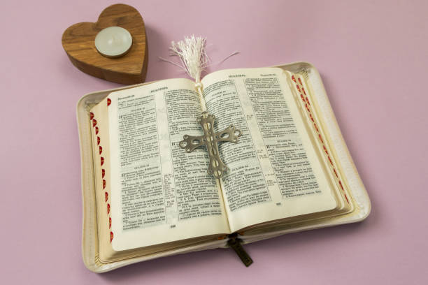 istock metal cross on an open bible in Russian 1465675087