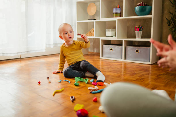 istock Toddler child playing with modeling clay in a kindergarten or ho 1465675308