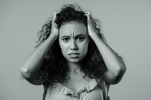 Worried confused woman, no, she forgot. Shocked girl feeling sorrow, regret, drama, failure, problems on black and white background. High quality photo
