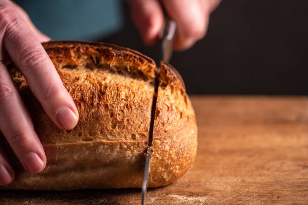 istock man cutting homemade bread 1465675898