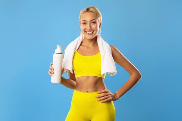 istock Sporty smiling woman posing at studio with water bottle 1465678330