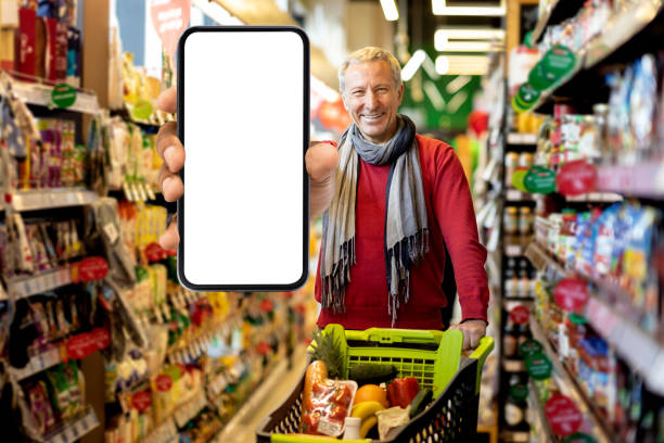 istock Positive senior customer showing smartphone with empty screen 1465678419