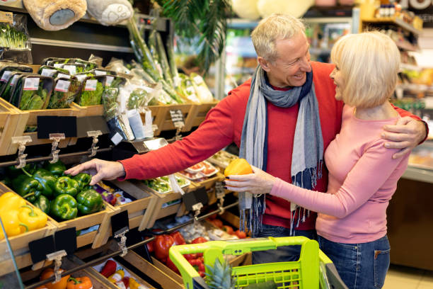 istock Attractive elderly couple making shopping at supermarket 1465678564