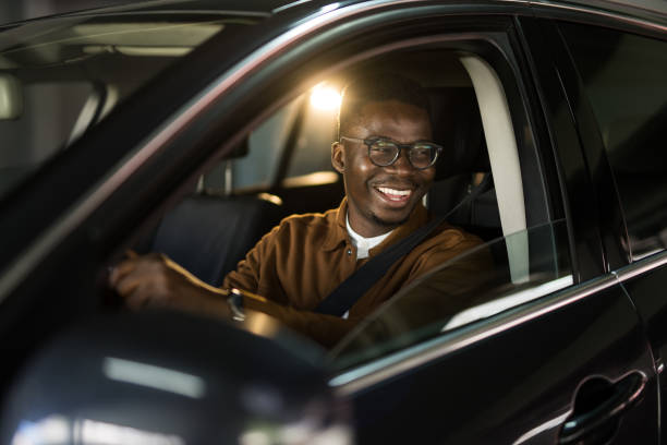 istock Cheerful African American man driving his car. 1465683923