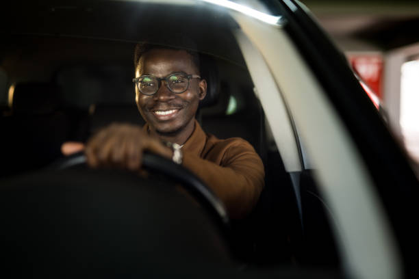 istock Happy African American man driving his car. 1465684462