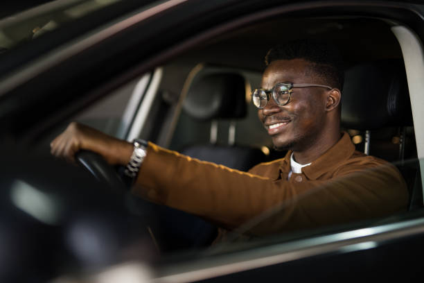 istock Handsome African American man driving his car. 1465684517