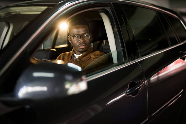 istock Handsome African American man driving his car. 1465684560