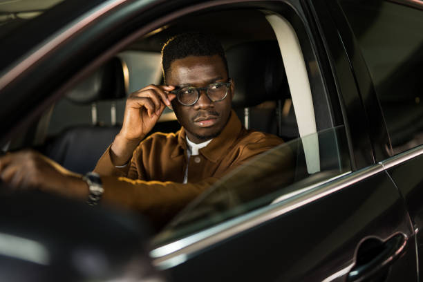 istock Handsome African American man driving his car. 1465684582
