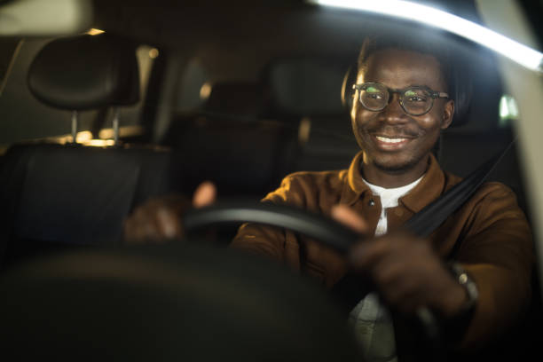 istock Happy African American man driving his car. 1465685300