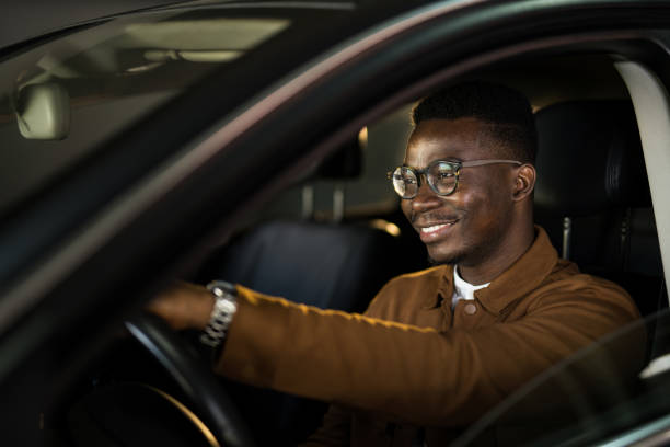 istock Handsome African American man driving his car. 1465685361