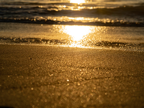 Sunset sunlight sparkling on sand