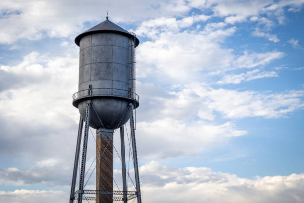 istock Silver Antique Water Tower Against a Partially Cloudy Sky 1465691135