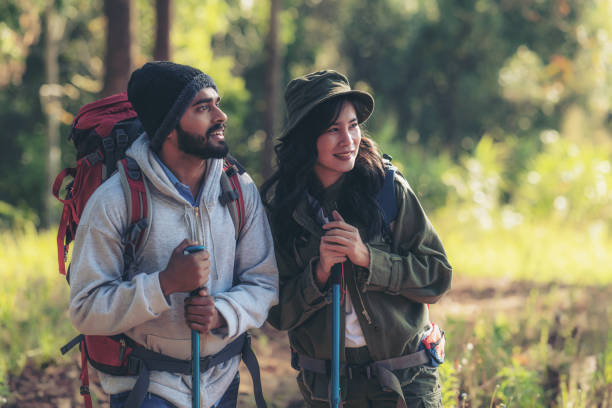 istock Hiking Couple backpacker in the pine forest. 1465691558
