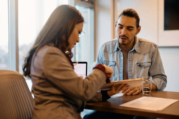 istock Job candidate and human resource manager using touchpad during a meeting in the office. 1465697174