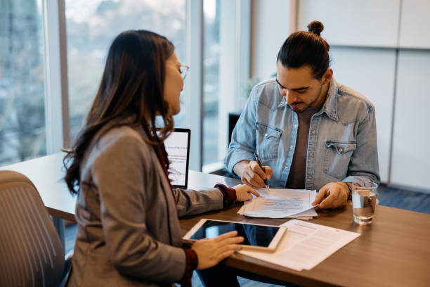 istock Happy candidate signing a contract during job interview in the office. 1465697176