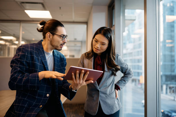 istock Business coworkers discussing while using digital tablet and working in the office. 1465697328