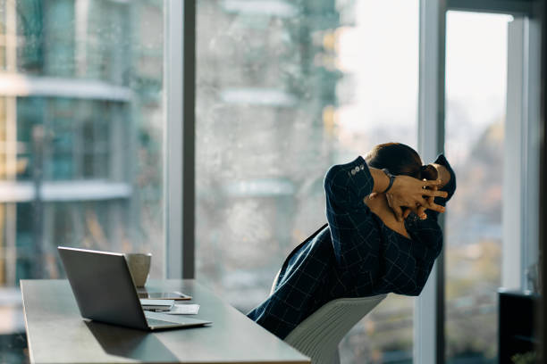 Back view of businessman having a break in the office.