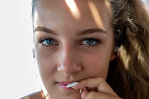 Close-up portrait of a girl listening to music on headphones.