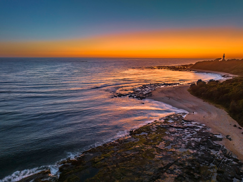 Aerial sunrise seascape from the sheltered bay of Cabbage Tree Harbour at Norah Head, NSW, Australia.