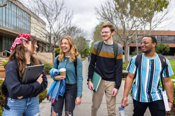 Diverse College Students Walking on Campus stock photo