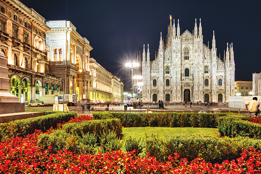 People enjoy Piazza del Duomo with the Milan Cathedral in the background in Milan, Lombardy, Italy in the evening.