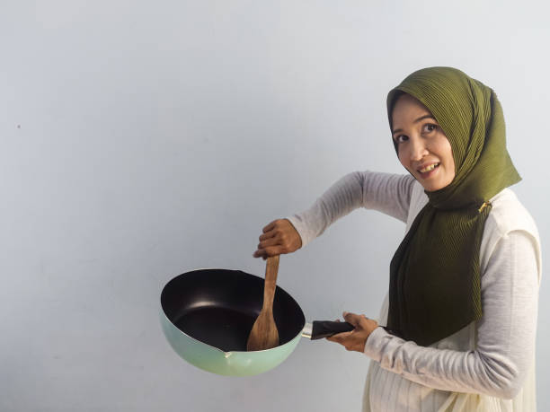 istock Asian woman with frying pan 1465718192