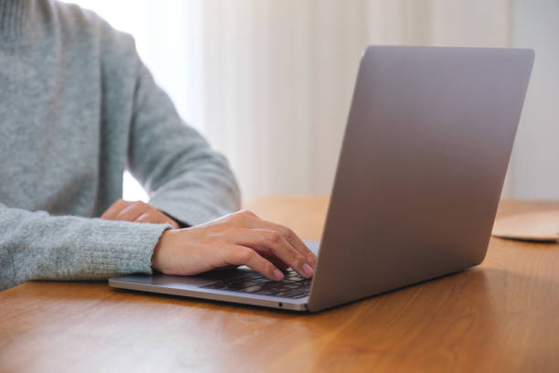 istock Closeup image of a woman working on laptop computer at home 1465719080