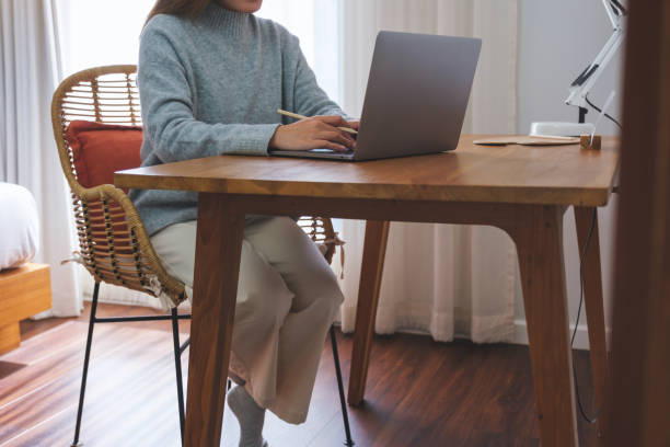 istock Closeup image of a young woman working on laptop computer at home 1465719082