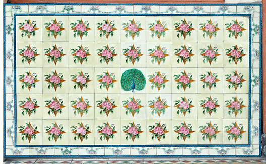 Rows of antique Nyonya Tiles with red roses. Traditional Peranakan cultural in Malaysia. Vintage Baba & Nyonya style floral tile pattern