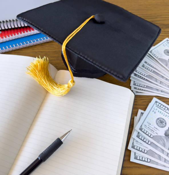 istock Saving tuition money mortarboard and 100 dollar bills 1465720376