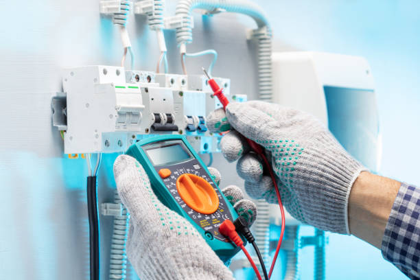 istock Electrician engineer tests electrical installations and wires in  electical panel.  Electrician measure voltage. 1465734938