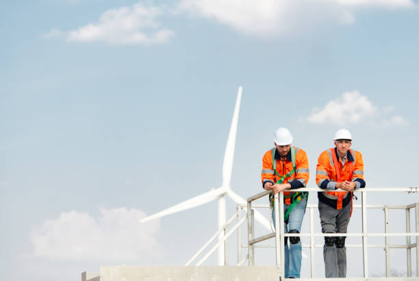 istock Surveyor and engineer Examine the efficiency of gigantic wind turbines that transform wind energy into electrical energy that is then used in daily life. 1465738151
