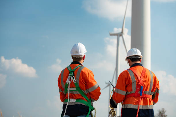 istock Surveyor and engineer Examine the efficiency of gigantic wind turbines that transform wind energy into electrical energy that is then used in daily life. 1465738319