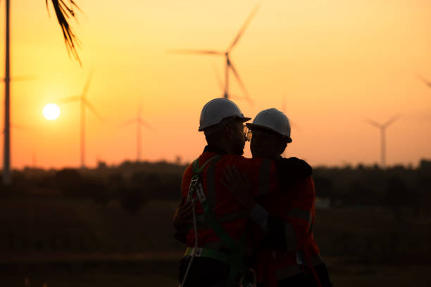 istock Engineers working on wind farms for renewable energy are responsible for maintaining large wind turbines. Returning from work during while the evening sun shines a beautiful golden light upon both of 1465740074