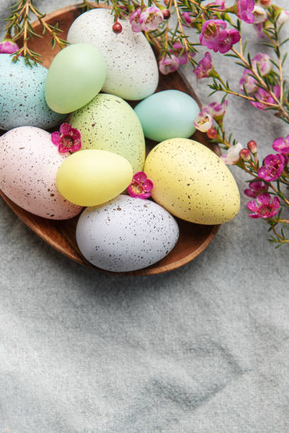 istock Easter decor. Colored Easter eggs on a wooden plate on the table. 1465742348